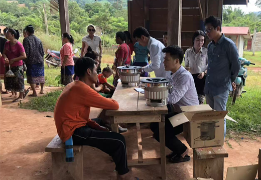 SSM team providing on-site operation guidance and after-sales support for stove products to customers in a rural community.