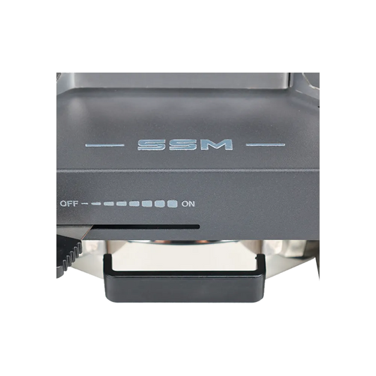 Close-up view of the SSM brand logo and precision OFF-to-ON fuel regulation control panel on the ethanol stove.