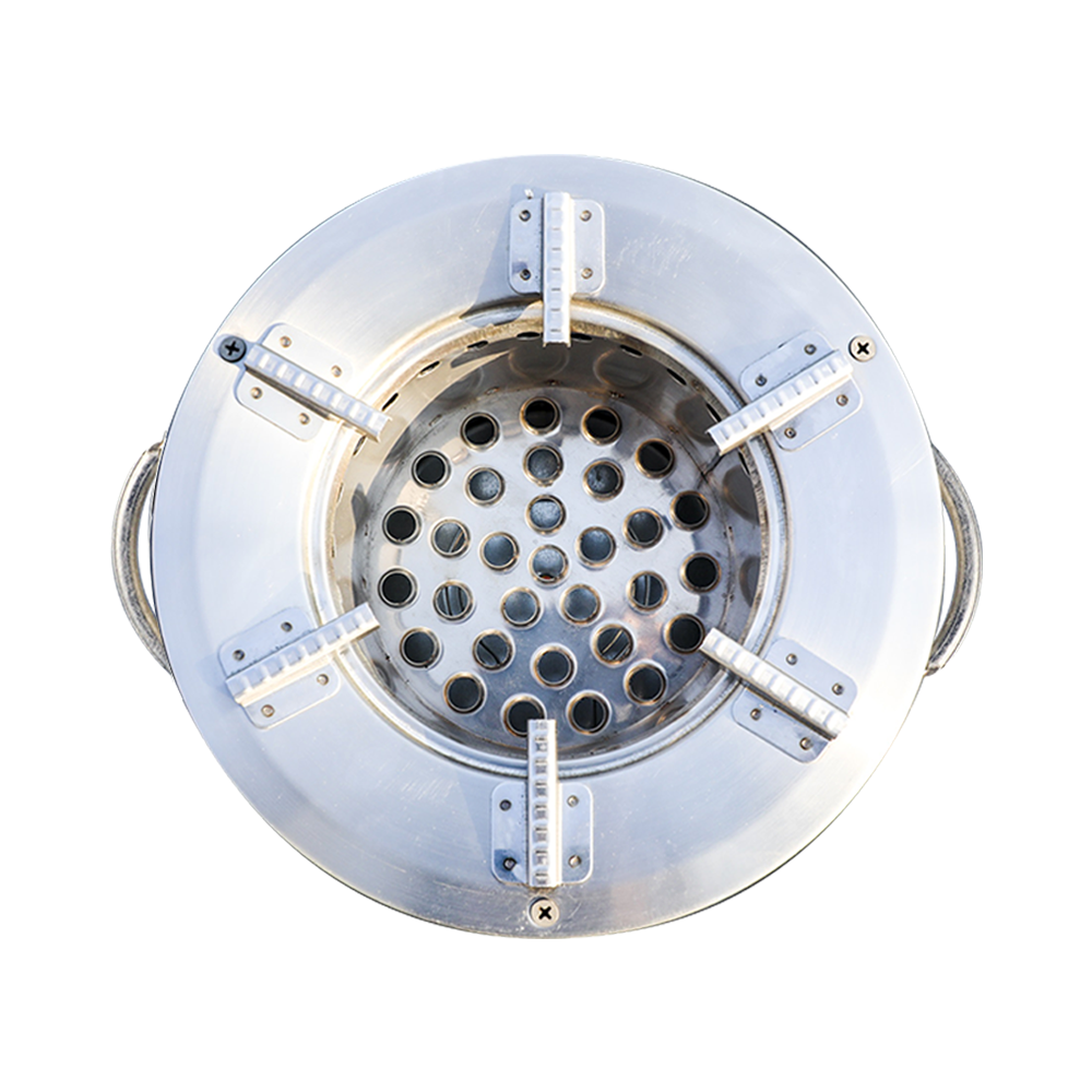 Top-down view of the C26-10B charcoal stove combustion chamber, showcasing the secondary air vent design and pot support grates for high thermal efficiency.