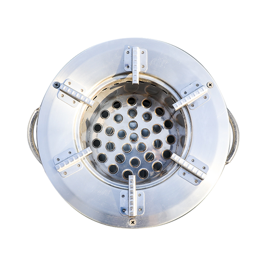 Top-down view of the C26-10B charcoal stove combustion chamber, showcasing the secondary air vent design and pot support grates for high thermal efficiency.